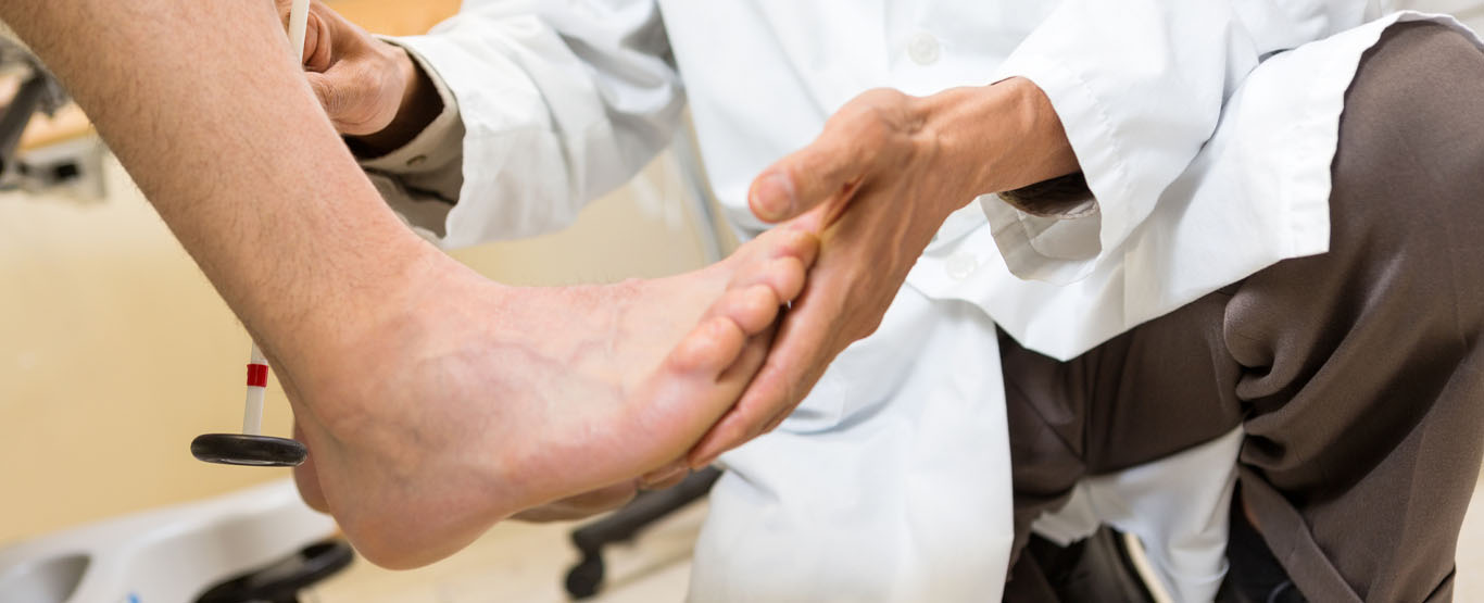 Clinician examining a patient’s foot